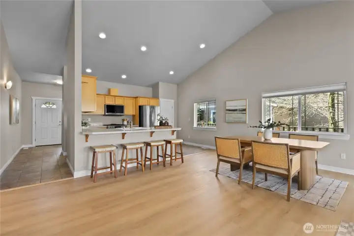 Open-concept dining and kitchen with breakfast bar seating