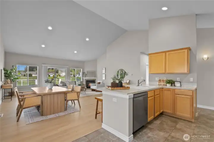 Kitchen layout with adjacent dining area and views into living space