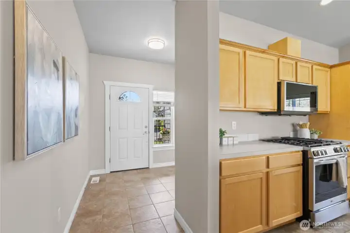 Entryway with tile flooring, natural light, and access to adjacent rooms