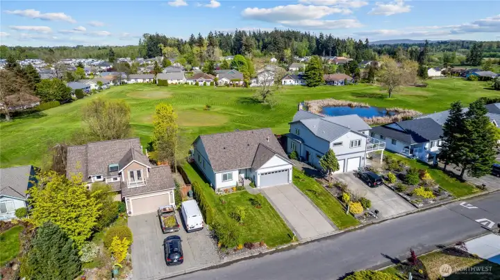 Aerial view highlighting the home’s position within the neighborhood and surrounding green space.