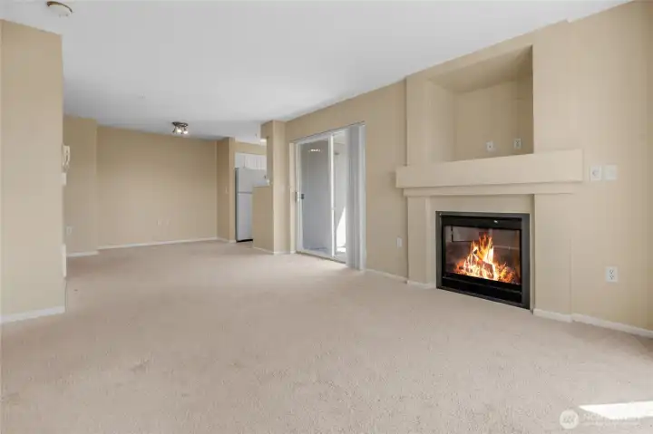 Living area looking back to dining area and kitchen. Also has gas fireplace (HOA paid). un-staged