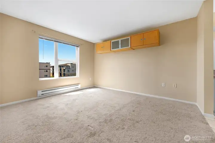 Primary bedroom with tons of natural light and views of City and beyond! un-staged