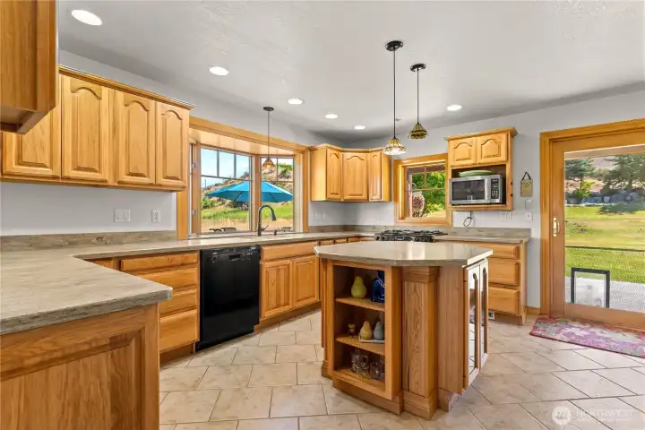 Expansive kitchen, bar, lots of storage, sliding doors to the covered patio