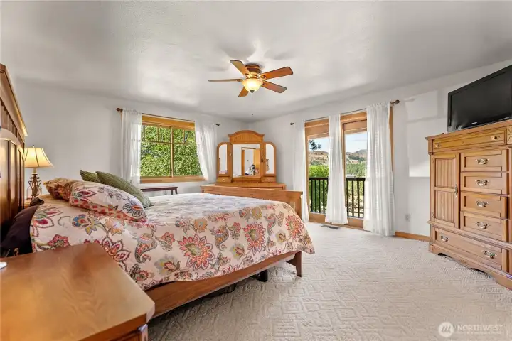 Primary bedroom with stunning views and access on to the covered deck and sitting area
