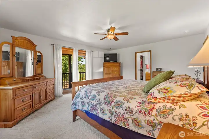 Primary bedroom with stunning views and access on to the covered deck and sitting area