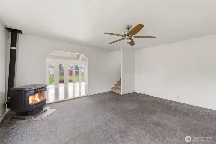 Living room with pellet stove view into sunroom