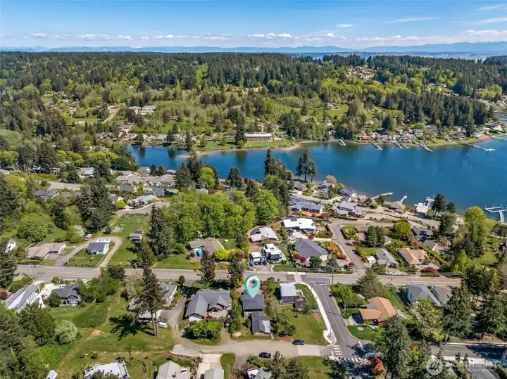 Bird's eye view of property looking east with home in the foreground.