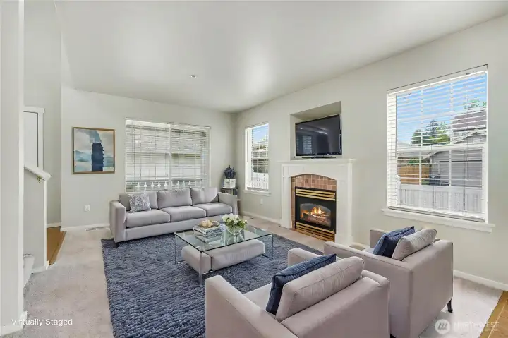 Cozy gas fireplace. Light and bright living room with lots of windows. (virtual staging)