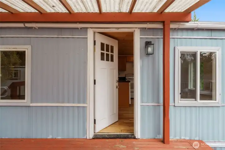 A welcoming covered entrance with charming touches that set the tone from the moment you arrive.
