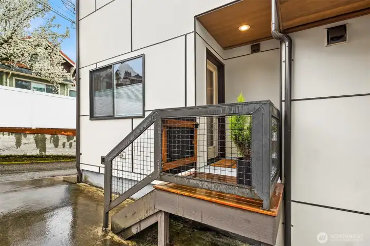 Back entrance from the parking space which leads into the dining and kitchen space. Back entrance from the parking space which leads into the dining and kitchen space.