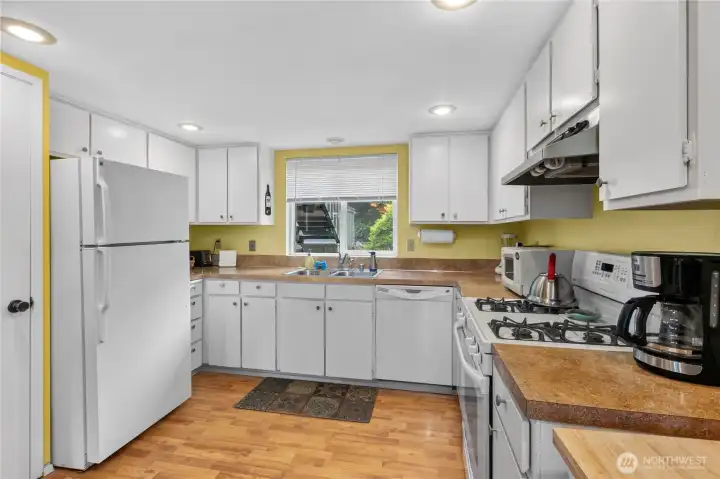 Functional workspace, abundant cabinetry, and natural light make meal preparation both convenient and enjoyable. Functional workspace, abundant cabinetry, and natural light make meal preparation both convenient and enjoyable.
