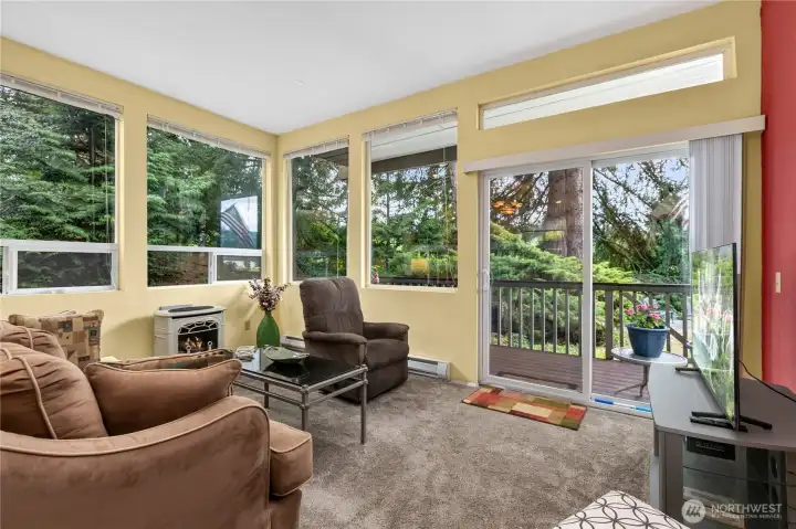 Relax in a light-filled living room with expansive windows and direct access to your private deck. Relax in a light-filled living room with expansive windows and direct access to your private deck.