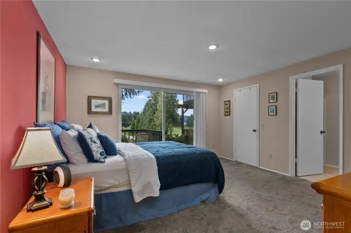 Spacious primary suite features oversized proportions, abundant natural light, and direct access to a private patio overlooking the golf course. Spacious primary suite features oversized proportions, abundant natural light, and direct access to a private patio overlooking the golf course.