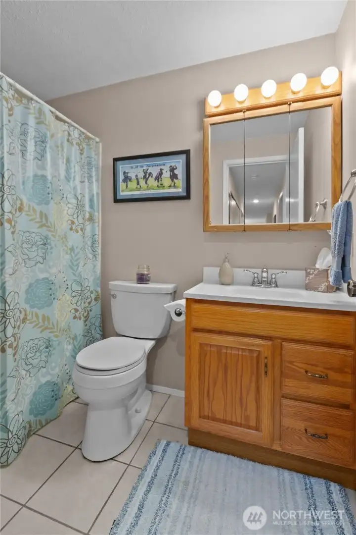 Full guest bath provides convenient access for family and visitors. Full guest bath provides convenient access for family and visitors.
