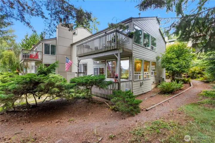 Well-positioned townhome featuring multiple outdoor living spaces, large windows, and a tranquil setting surrounded by established landscaping. Well-positioned townhome featuring multiple outdoor living spaces, large windows, and a tranquil setting surrounded by established landscaping.