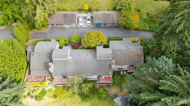 A bird's-eye view highlights the condo's location within the community, showcasing nearby parking, landscaped grounds, and surrounding green space. A bird's-eye view highlights the condo's location within the community, showcasing nearby parking, landscaped grounds, and surrounding green space.