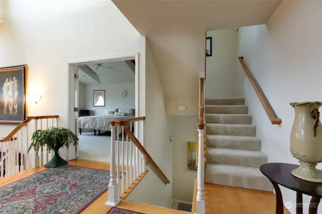 Main level - stairs to left to two additional bedrooms, garage and 725 feet of bonus storage space. Stairs to right to open loft/flex space