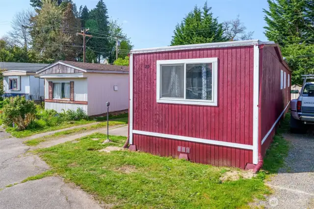 Front of home, reserved parking spots on left side of home.
