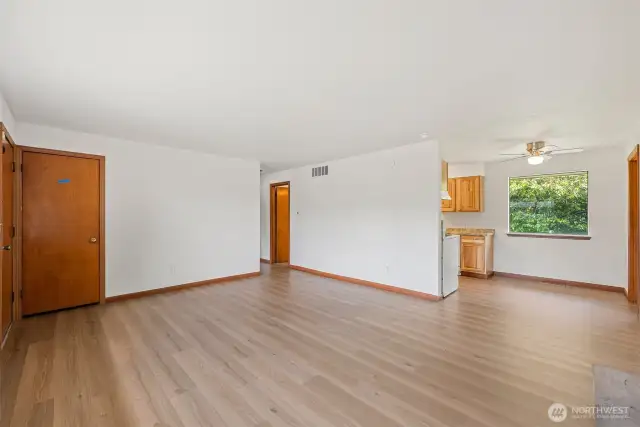 Front entry, living room, dining space and access to hallway and kitchen.
