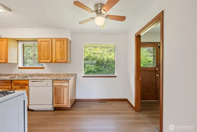 Kitchen. All appliances currently at property stay with property. Archway leads to outside access, laundry room and door to garage.
