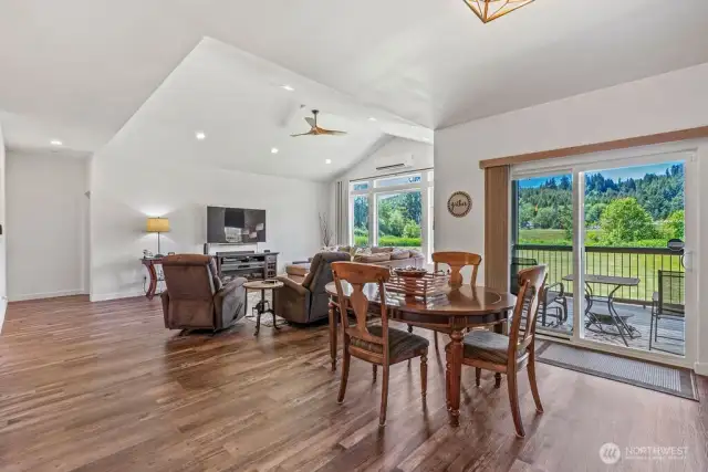 Dining area with not just one, but two sliders to the massive, fully covered back deck. High ceilings live large!