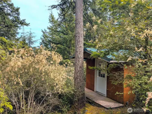 Cozy camping cabin with water view potential.