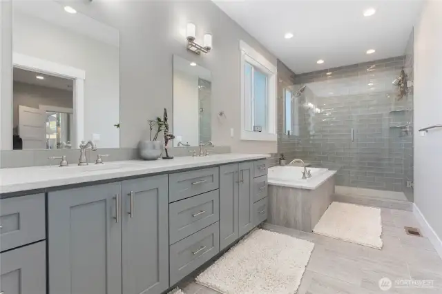Primary Ensuite with double vanity and tiled shower and soakers tub