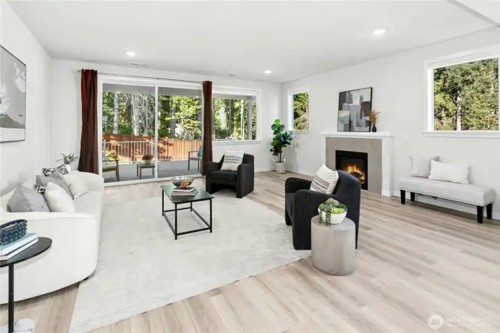 The huge living room has plenty of seating space, a gas fireplace, and a pretty outlook onto the private backyard.