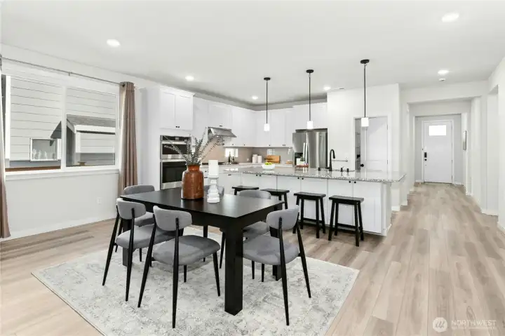 Kitchen island with space for barstools. Slab granite island has extra cabinet storage beneath.