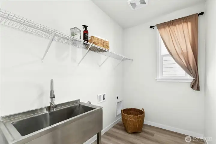 Separate laundry room with large sink just off the entry.