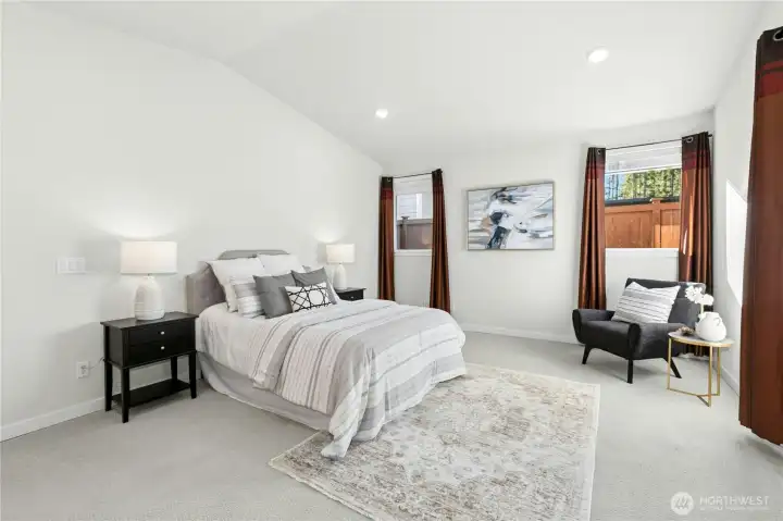 This over-sized primary bedroom has lots of room for a seating area, dressers, and a king-size bed!