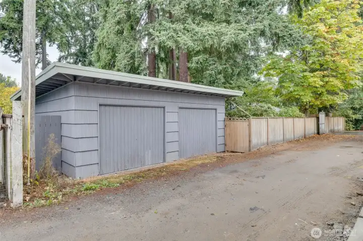 Detached garage with single door that opens to easement off 25th Ave.