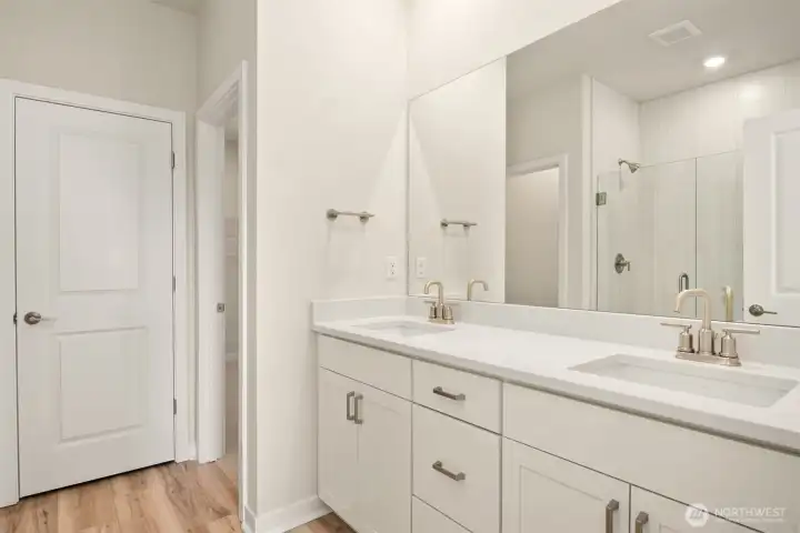 Double sink and linen closet in primary bath