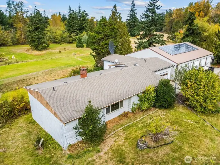 Aerial view highlighting the home’s generous lot and scenic backdrop.