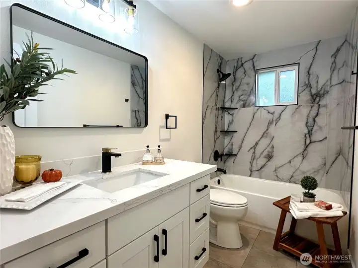 Elegant Full Bathroom w/ceramic tiles, blending style and durability.