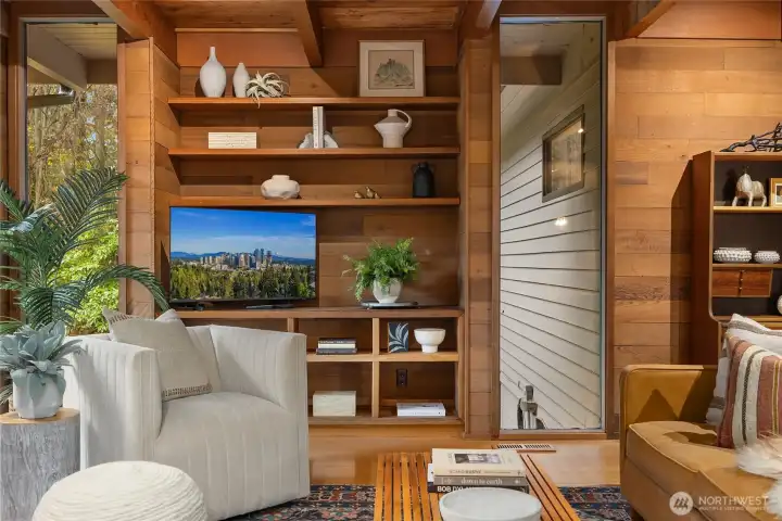 Thoughtful built-ins flanked by windows in the living room.