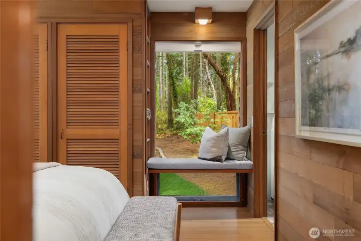 Bedroom #2 with Window seat and generous closet. Door to right leads to laundry room.