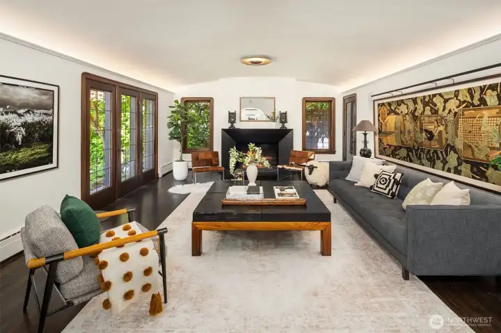 Coved barrel ceilings lit up, original curved mahogany trim, leaded glass windows and a blackened steel fireplace.