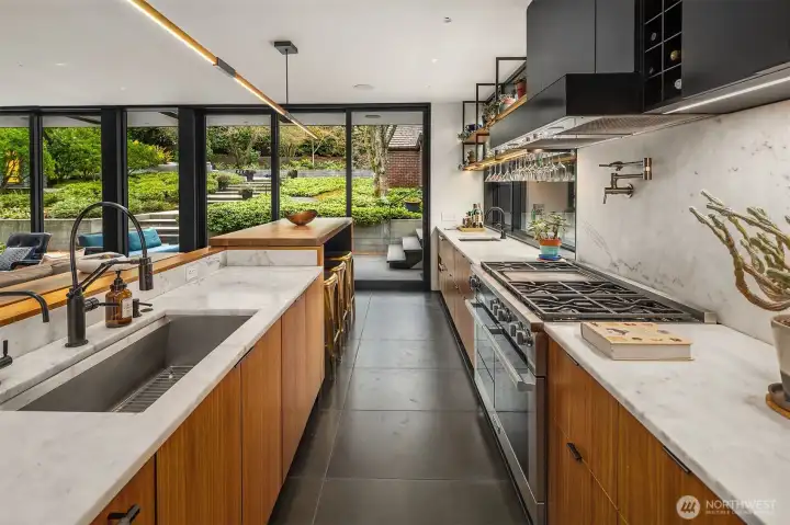 Custom walnut cabinets, high end appliances, inset outlets, every detail has been perfected in this chefs kitchen.