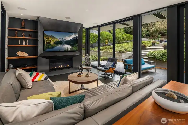 Basalt tile floors that flow to the patio and a blackened steel fireplace mirrors the fireplace in the original living room