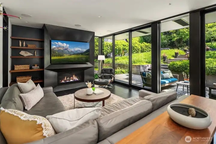 Basalt tile floors that flow to the patio and a blackened steel fireplace mirrors the fireplace in the original living room