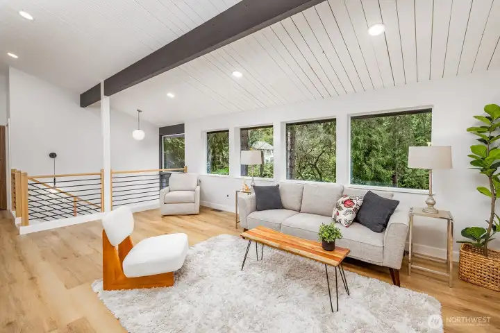 Looking from the fireplace back towards the entry and large picture windows.  Really open and gracious living space for lots of variety of daily living and entertaining.