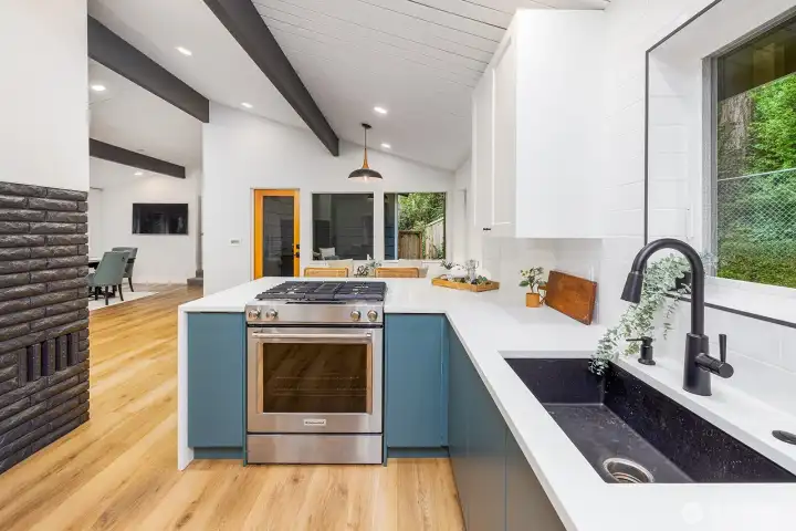 Gorgeous and open kitchen overlooks the private backyard, has bar eating space, vaulted ceilings and lots of lighting.  Undermount and oversized kitchen sink and upgraded gas range with electric oven, the ideal combination for good cooking!