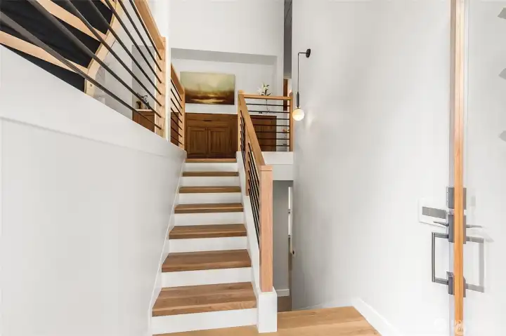 Entry level view of staircase leading up to main floor.