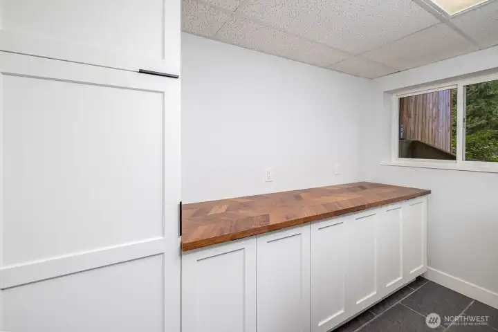 Lower level kitchenette. Larger butcher block countertop, great storage and designed to accommodate a microwave, hot plate, toaster oven or airfryer.