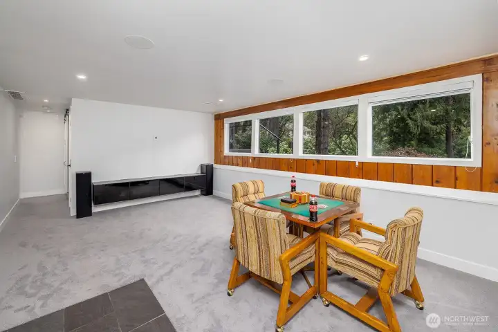 Lower level bonus room! Excellent natural light, and built in speakers. In the distance, a built in media space and speakers.  All walls, where necessary have the smurf tubing so no wires need to show.