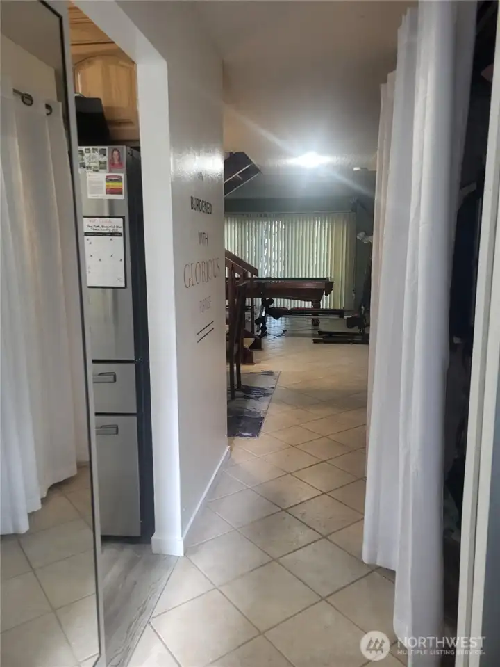 View as you enter the unit. Kitchen and half bath to the left, dining room and family room straight ahead. Coat closed and storage behind the curtain.