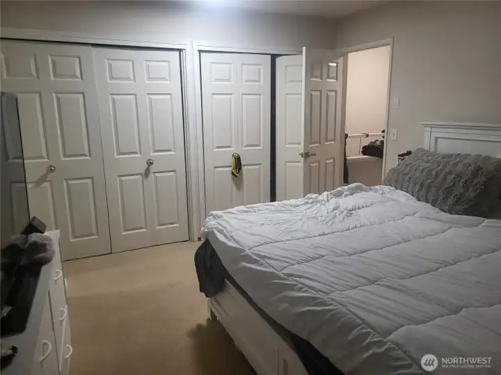Main bedroom with large closet space. Main bedroom is separated from other bedrooms by the stairs, bathroom and hallway. Closet organizers inside the closet. Holds a king sized bed with a lot of extra spcace.