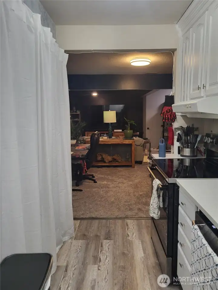 Kitchen into the living room. Large pantry space on the left.