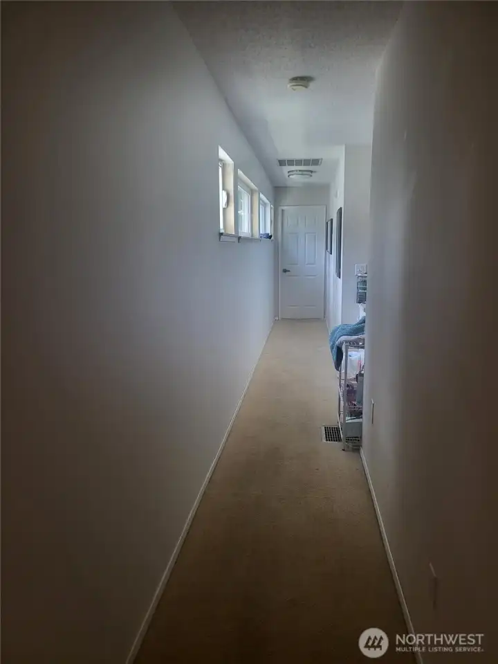 Hallway to two bedrooms and one bathroom.